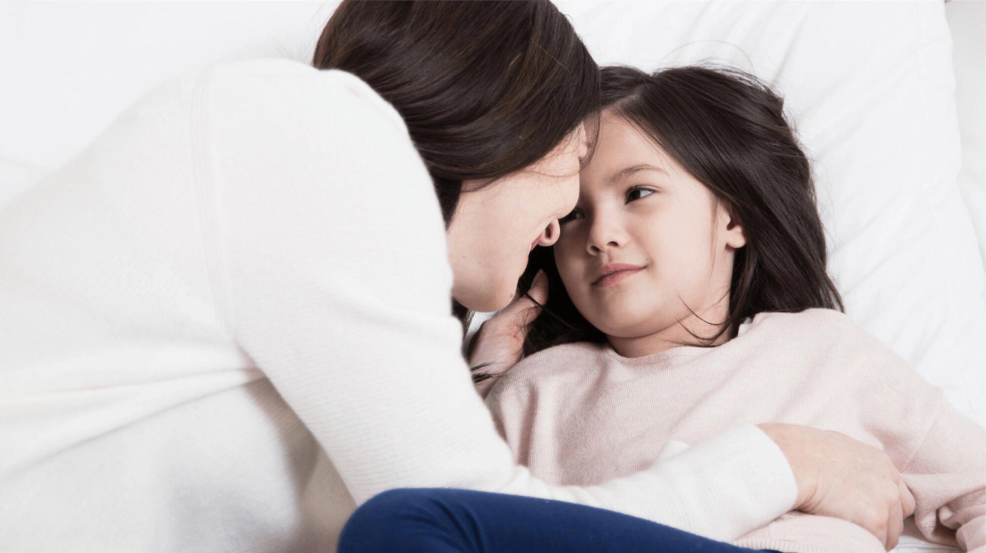 Mother laying with her daughter
