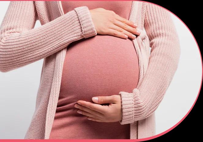 Pregnant woman gently cradling her belly