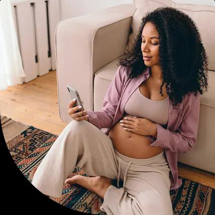 Expectant mother gently touching her belly