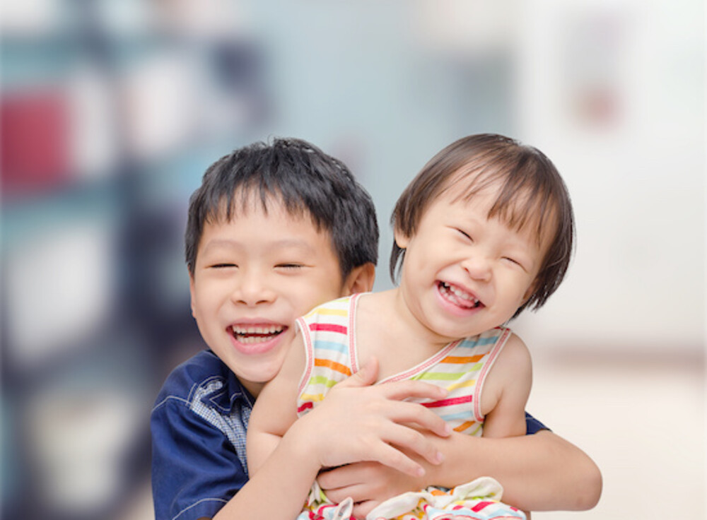 Photo of two chinese siblings smiling