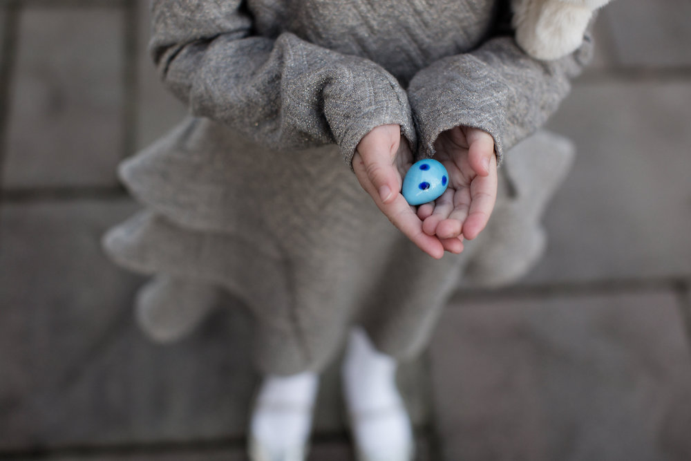 Woman holding a wooden egg in her hands